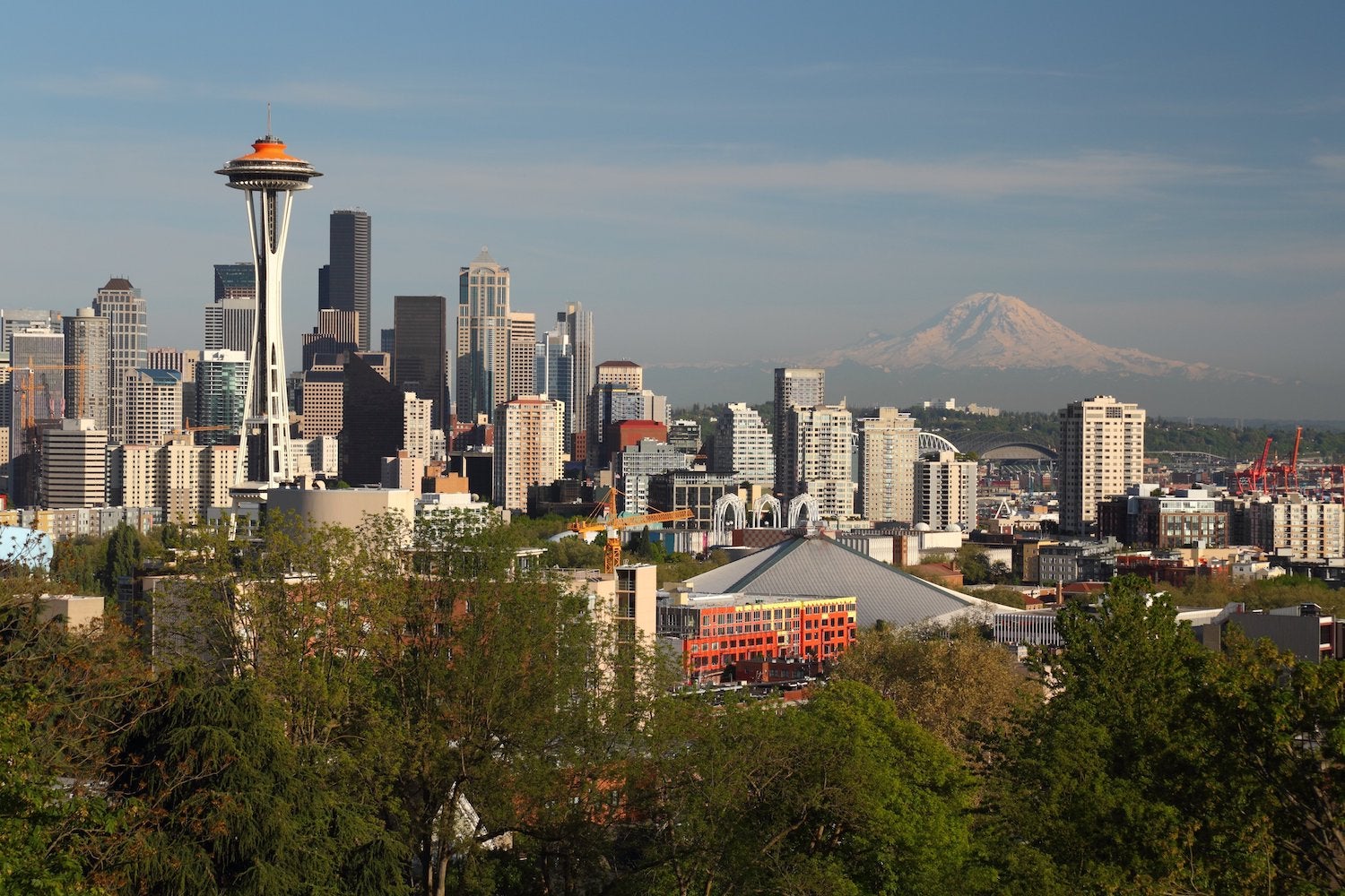 Seattle, Washington skyline near sundown. The landmark Space Needle with Mt. Rainier in the background stand out